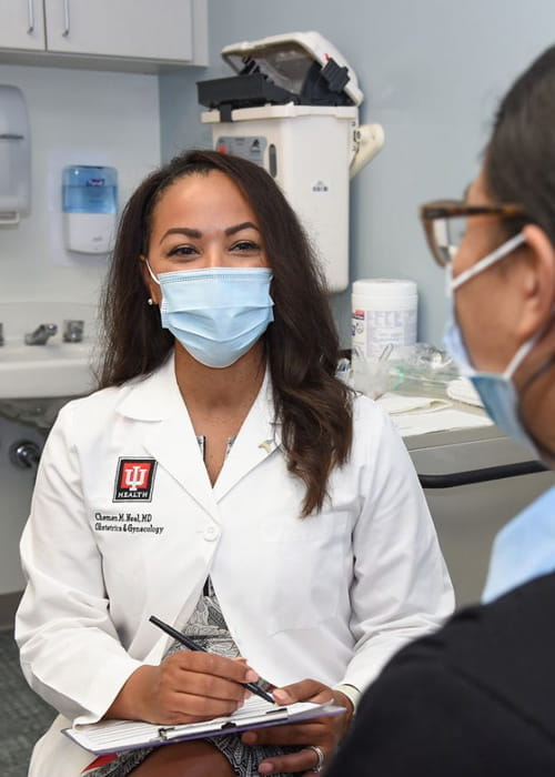 chemen neal, md speaks with a patient in the clinic