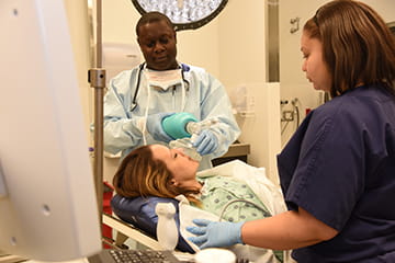 Doctor giving oxygen to patient in hospital