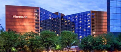 sheraton hotel lit up at sunset