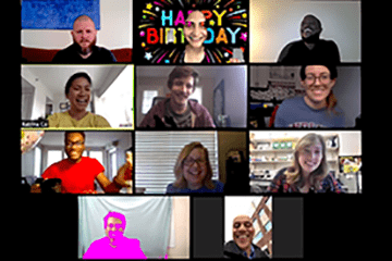 A screen shot of 11 people smiling during a virtual meeting.