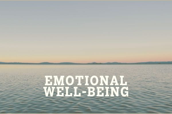 a photo of a calm lake with sunset in the distance