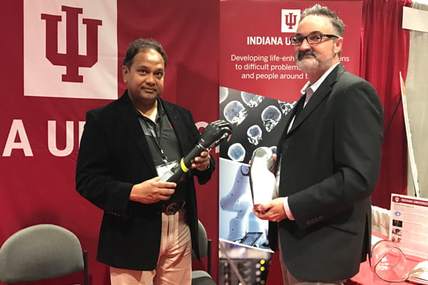 Jeffrey Denune and Chandan Sen display prostheses at a conference