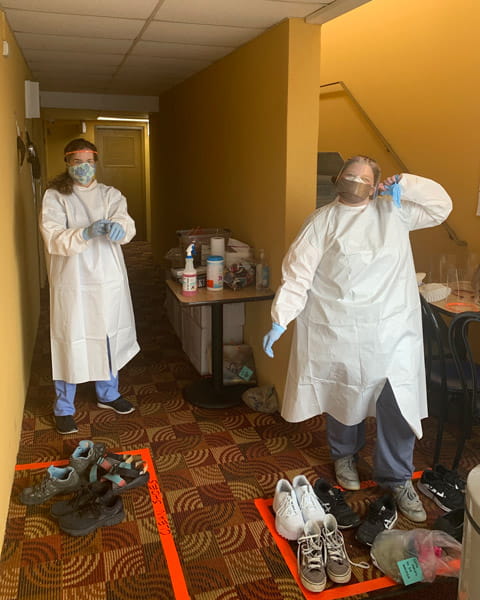 Shalom Community Center isolation shelter staff in PPE ready to pick up a guest