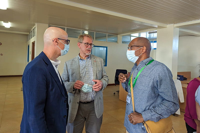 Three men having a conversation