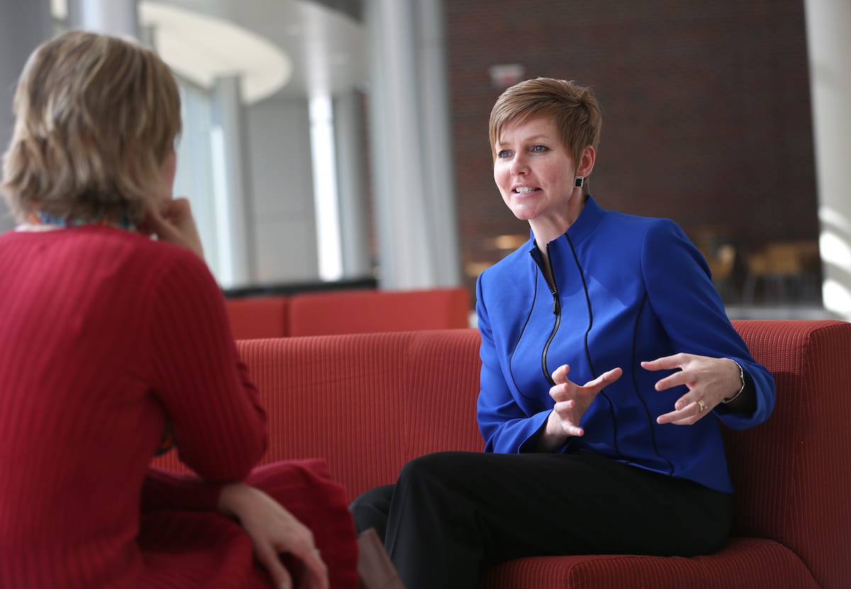 Mary Dankoski talking with a colleague