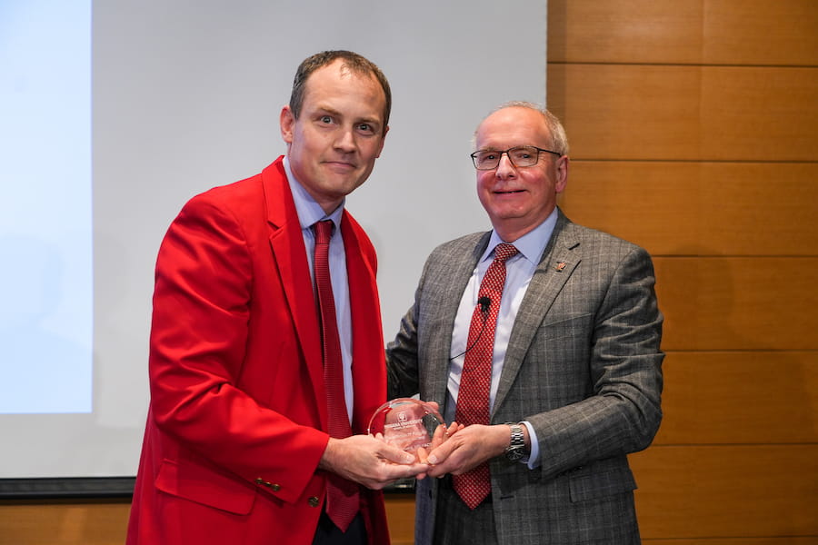 Michael Moore, MD, with Dean Jay Hess and thee Faculty Mentoring Award