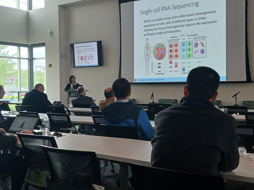 a research speaks in front of projected slides