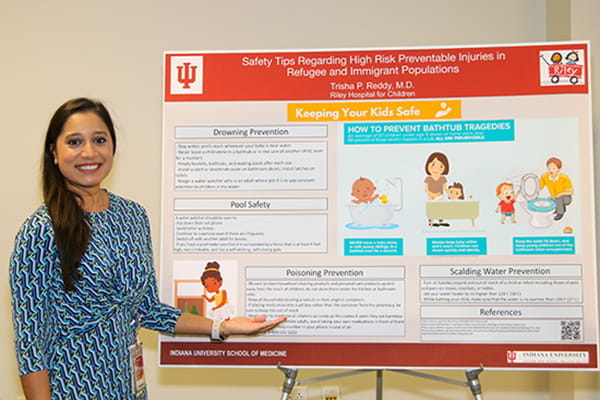 Woman standing in front of a research poster