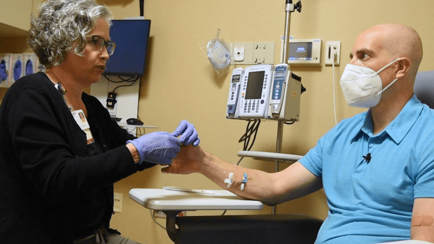 Massage therapist Michelle Bailey works on Sean Kern's hands to prevent neuropathy.