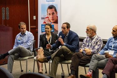 Sean Kern speaking, seated with other testicular cancer experts