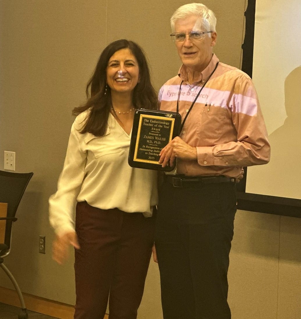 Dr. Walsh, right, accepts his award.