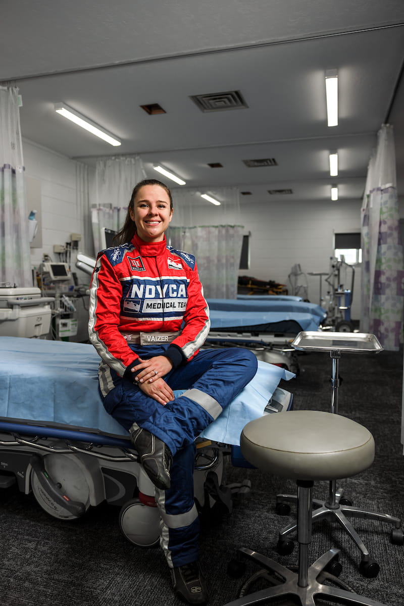 Julia Vaizer sit on a bed in the infield care center