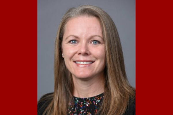 Portrait of Amanda Benaderet, MD, MPH wearing black top on a grey background