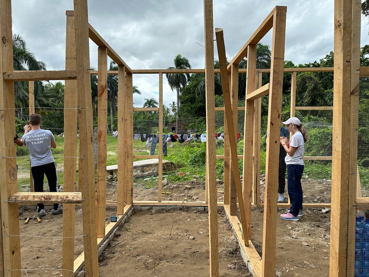 Elizabeth Baker works on the wood frame of a bottle house in the Dominican Republic.