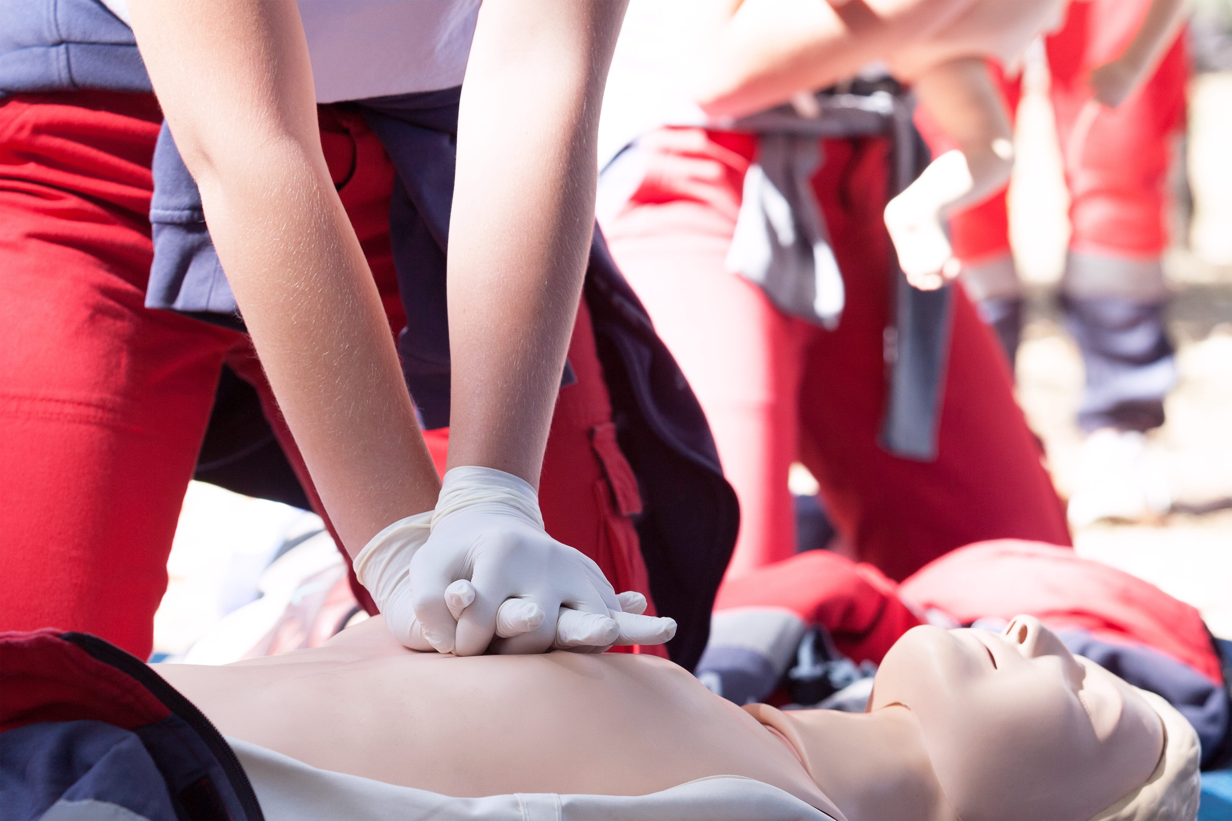 Paramedic demonstrates CPR on a dummy
