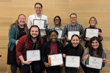 Dr. Jenny Baenziger with eight other people holding certificates