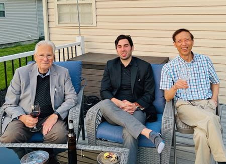 Dr. Gross with Ed Rogers and Riyi Shi enjoying conversation outside a home