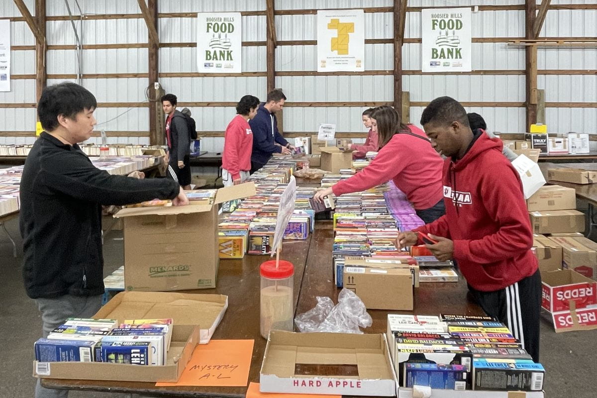 students work at the Hoosier Hills Food Bank to sort book donations