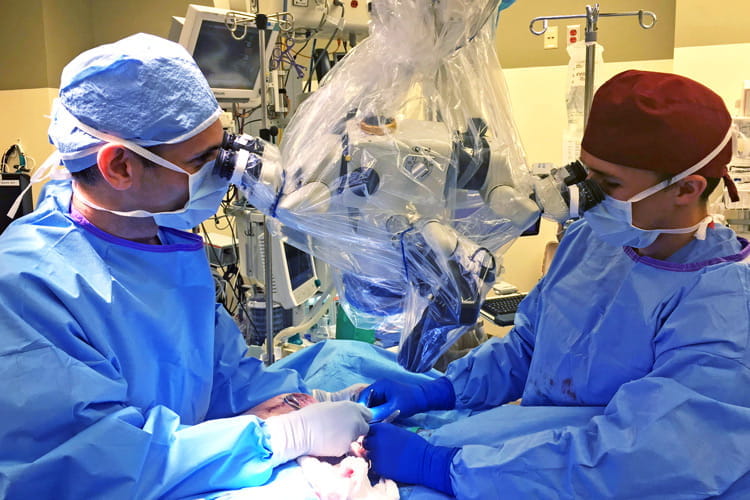 Al Hassanein, MD, at work in the operating room with a resident