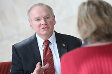 the dean speaks to a faculty member