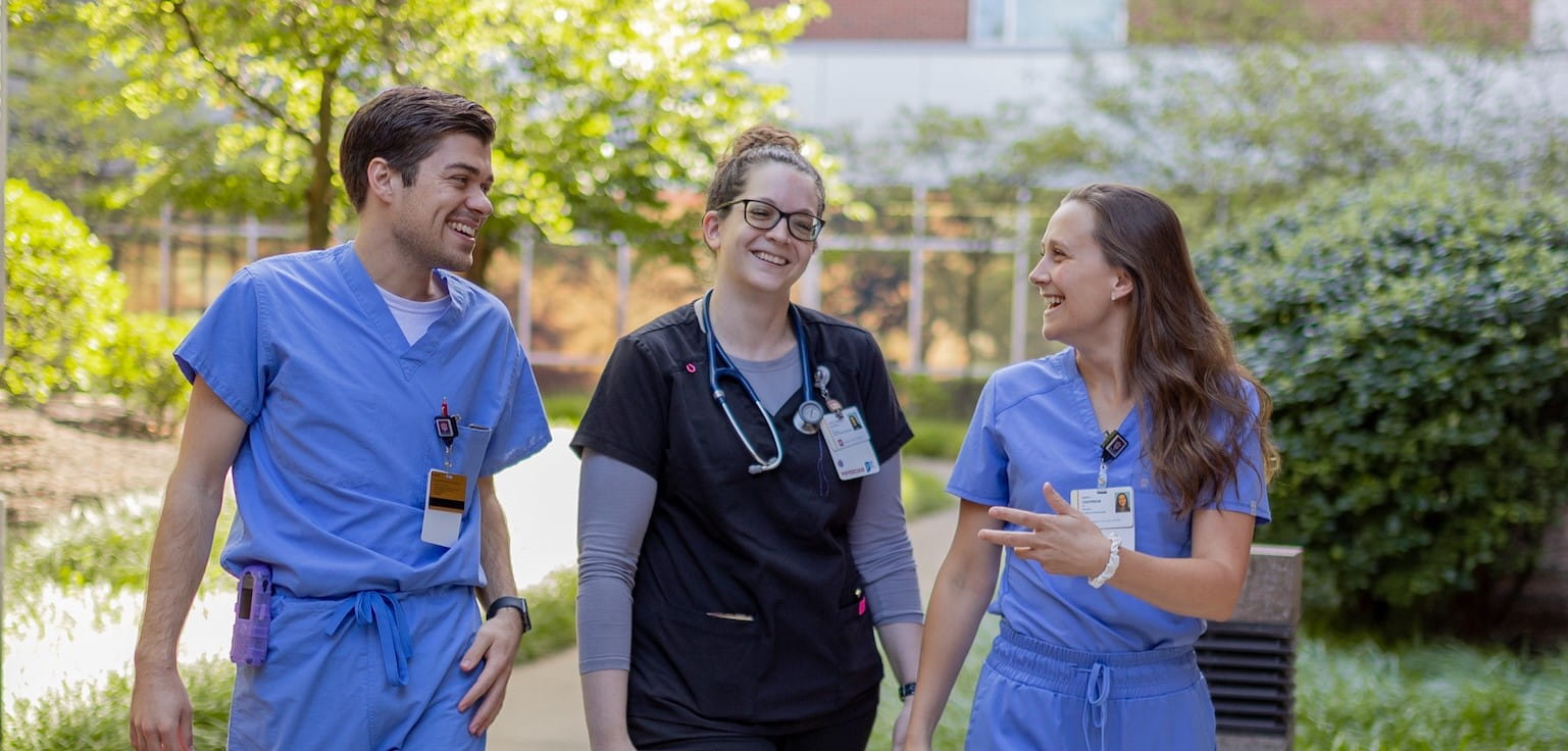 three residents walk outside in muncie