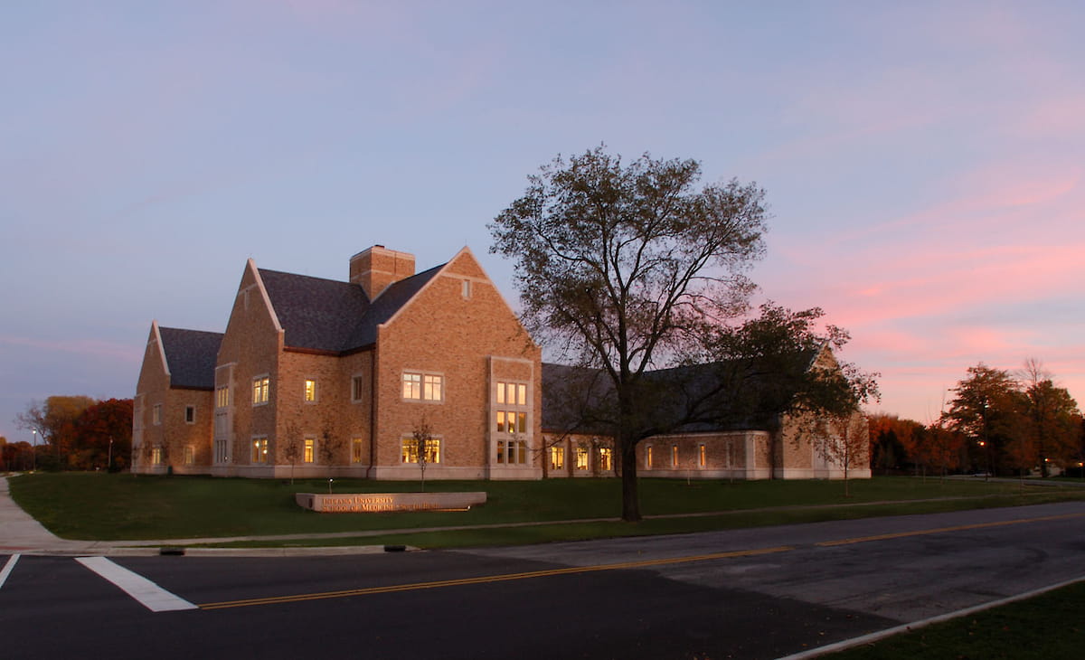 south bend campus building with dramatic sunset