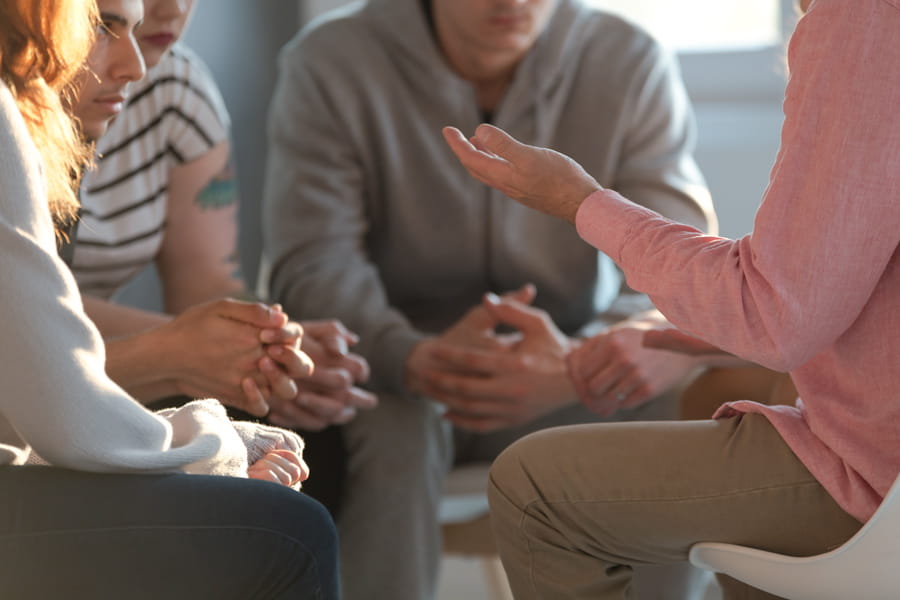 close up of a therapist gesticulating in a group session