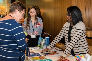 People speaking to each other at the Caregiver Symposium