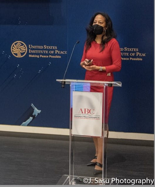 Khadijah Breathett, MD, speaks at a podium at the Institute for Peace.
