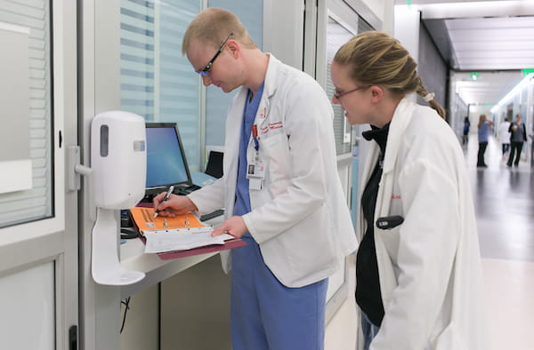 two students at work in the clinic at Eskenazi hospital