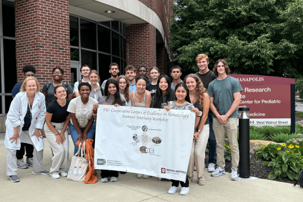 Group of IU-CCEH workshop participants from 2024 pose outside of the Wells Center building