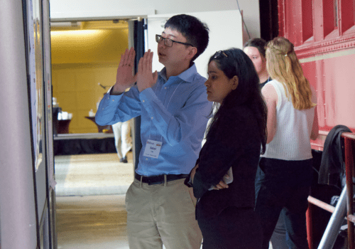 Breath Summit 2024 poster presenter explaining their research to another guest