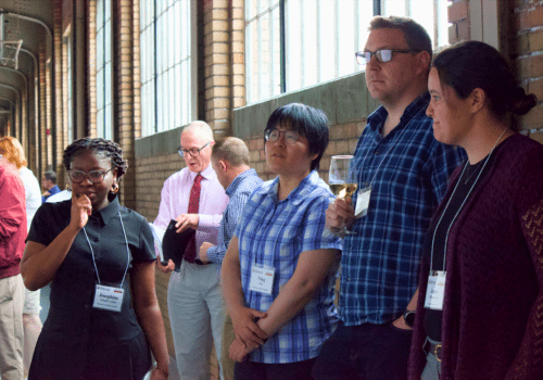 Four Breath Summit 2024 attendees admiring a scientific poster