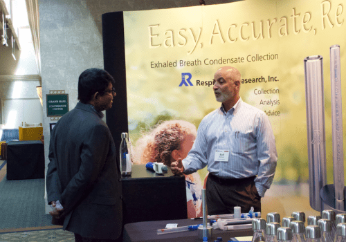 A Breath Summit 2024 sponsor chatting with an attendee