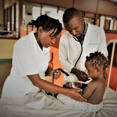 Clinicians and patient at a hospital in Kampala, Uganda