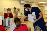 Johnny Krasinkiewicz, fellow, personally delivers a box of donuts to a nursing unit at Riley Hospital on behalf of the entire Herman B Wells Center.