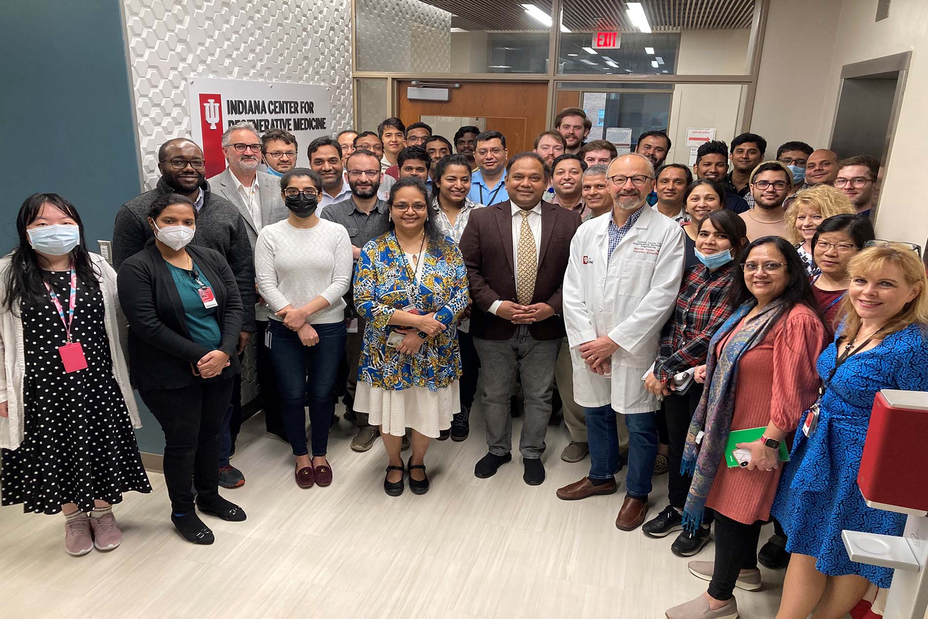 Investigators and staff from the Indiana Center for Regenerative Medicine and Engineering gather at entrance of the lab. 