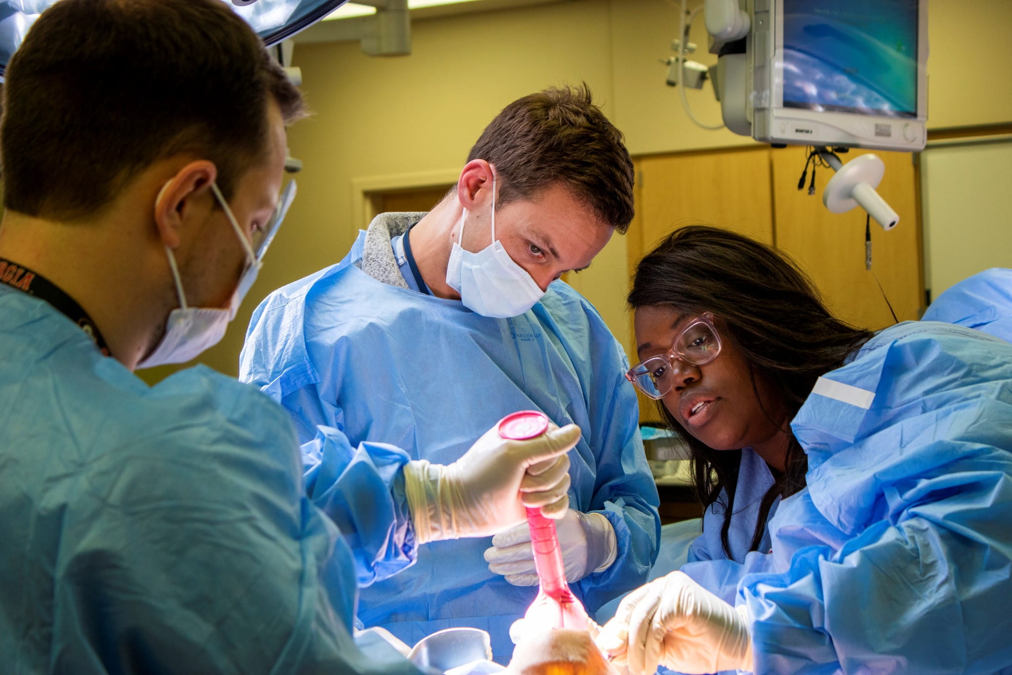 Dr. Imeokparia, Folasade working with residents during a surgery lab