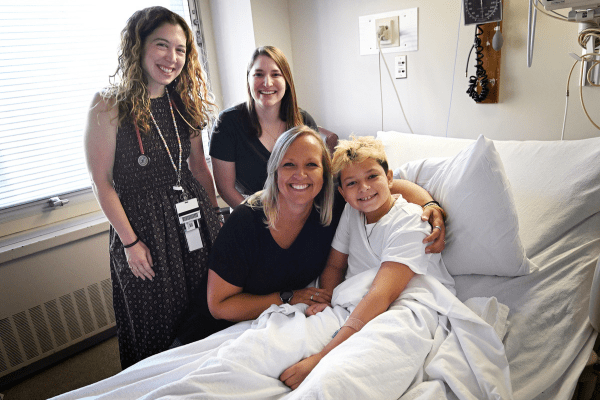 Emily Sims, Ellie Moreau, Miriam Davis and Heath Davis in a clinic room.