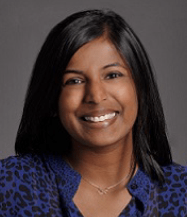 Headshot of a woman with dark hair and a blue shirt