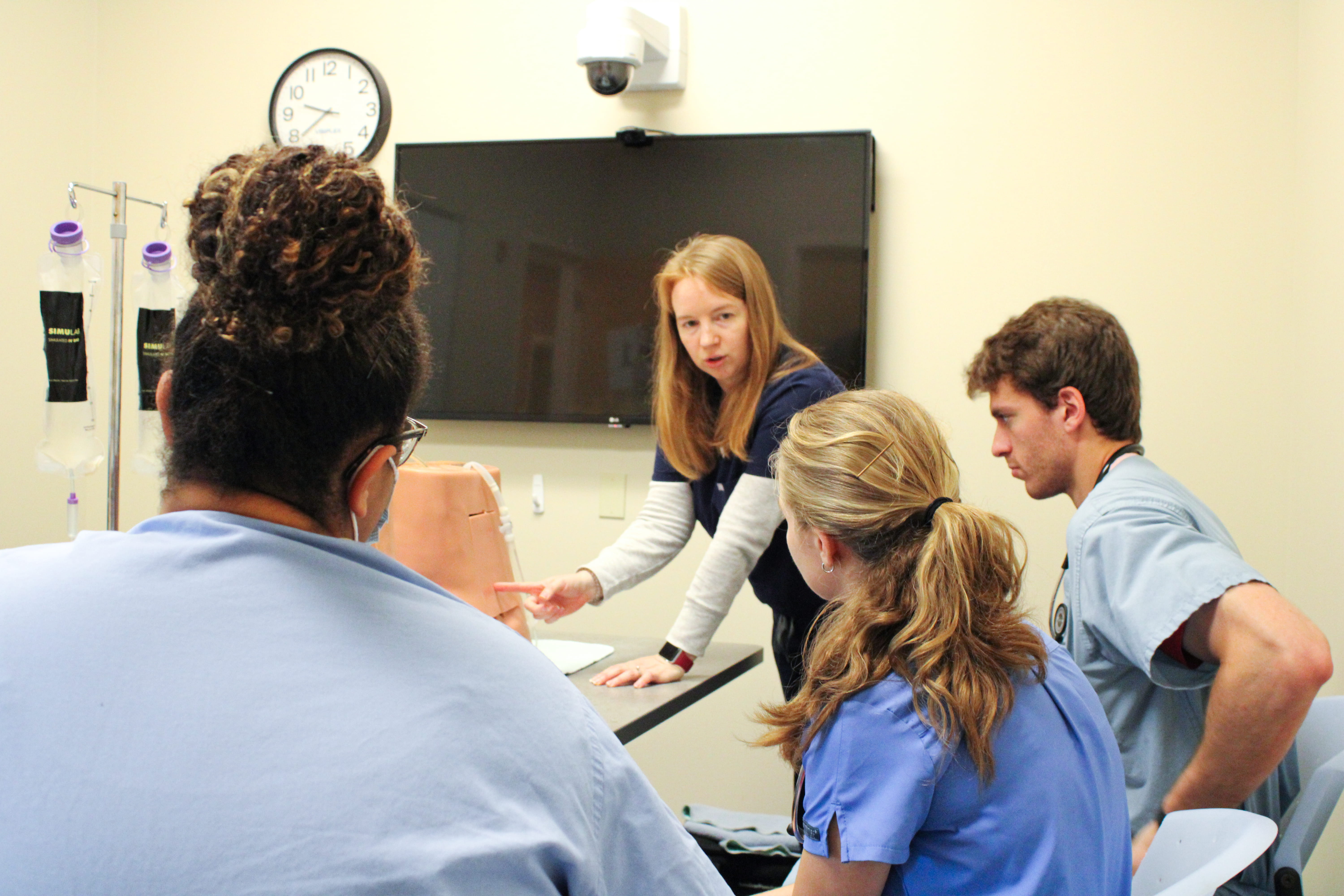 Dr. Rachel Day instructing medical students on how to perform a lumbar puncture. 
