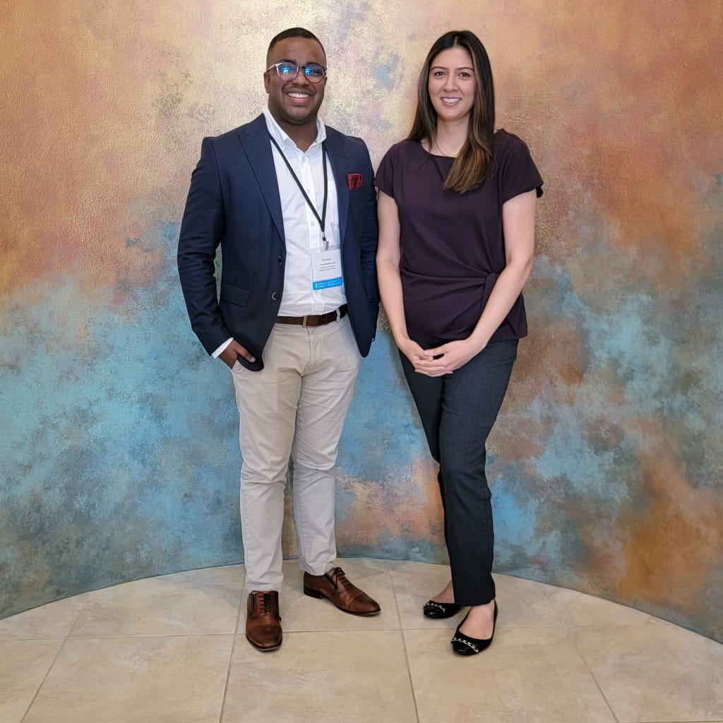 two residents stand together for a photo at an event