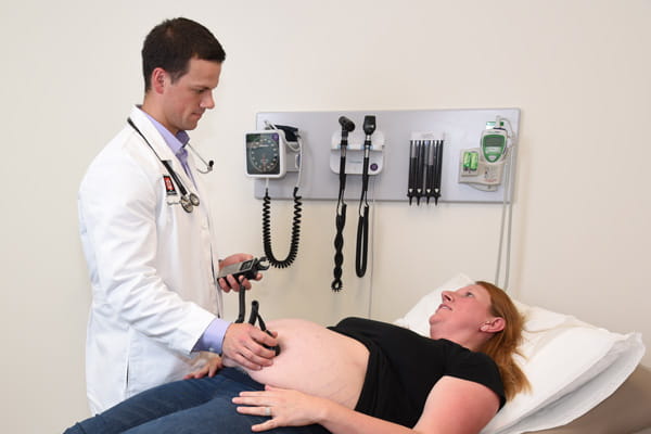 a resident examines a patient in the maternity care rotation
