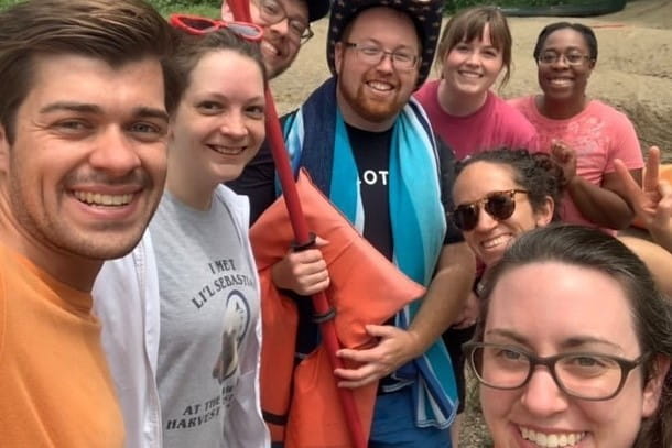 residents smile for a selfie while out on a canoeing trip