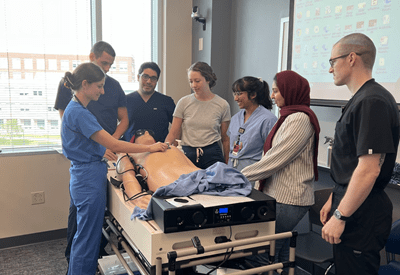 A group of residents gathered to learn a procedure.