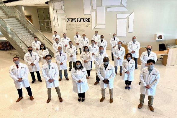 2020 residents stand wearing masks and socially distanced