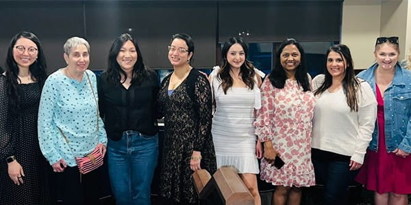 a row of diverse women standing together and smiling