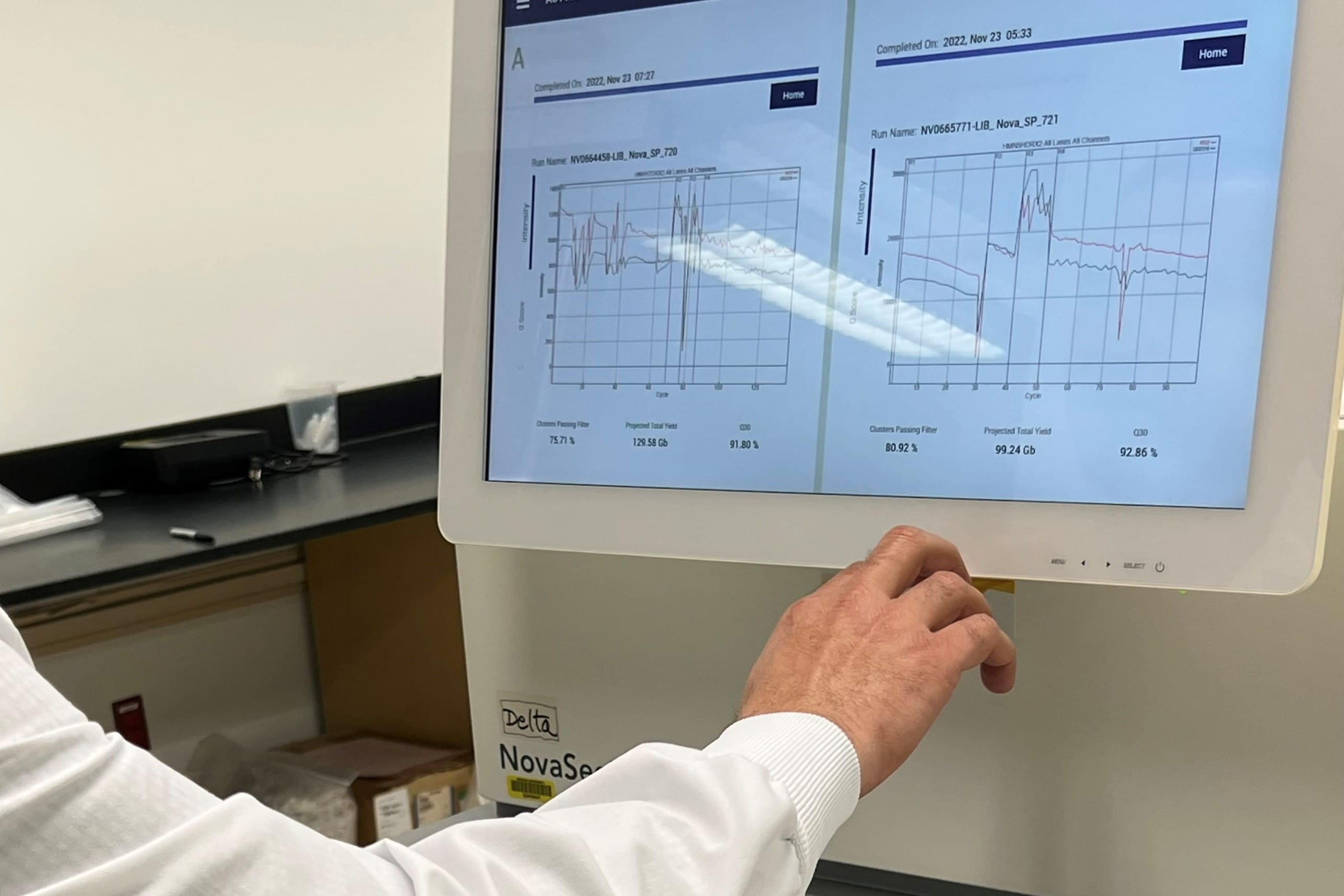 a hand reaches out and points to results on an equipment readout
