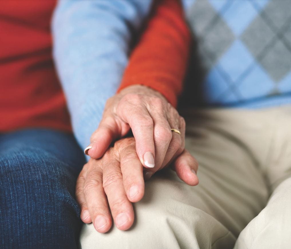 a close up photo of an elderly couple's clasped hands
