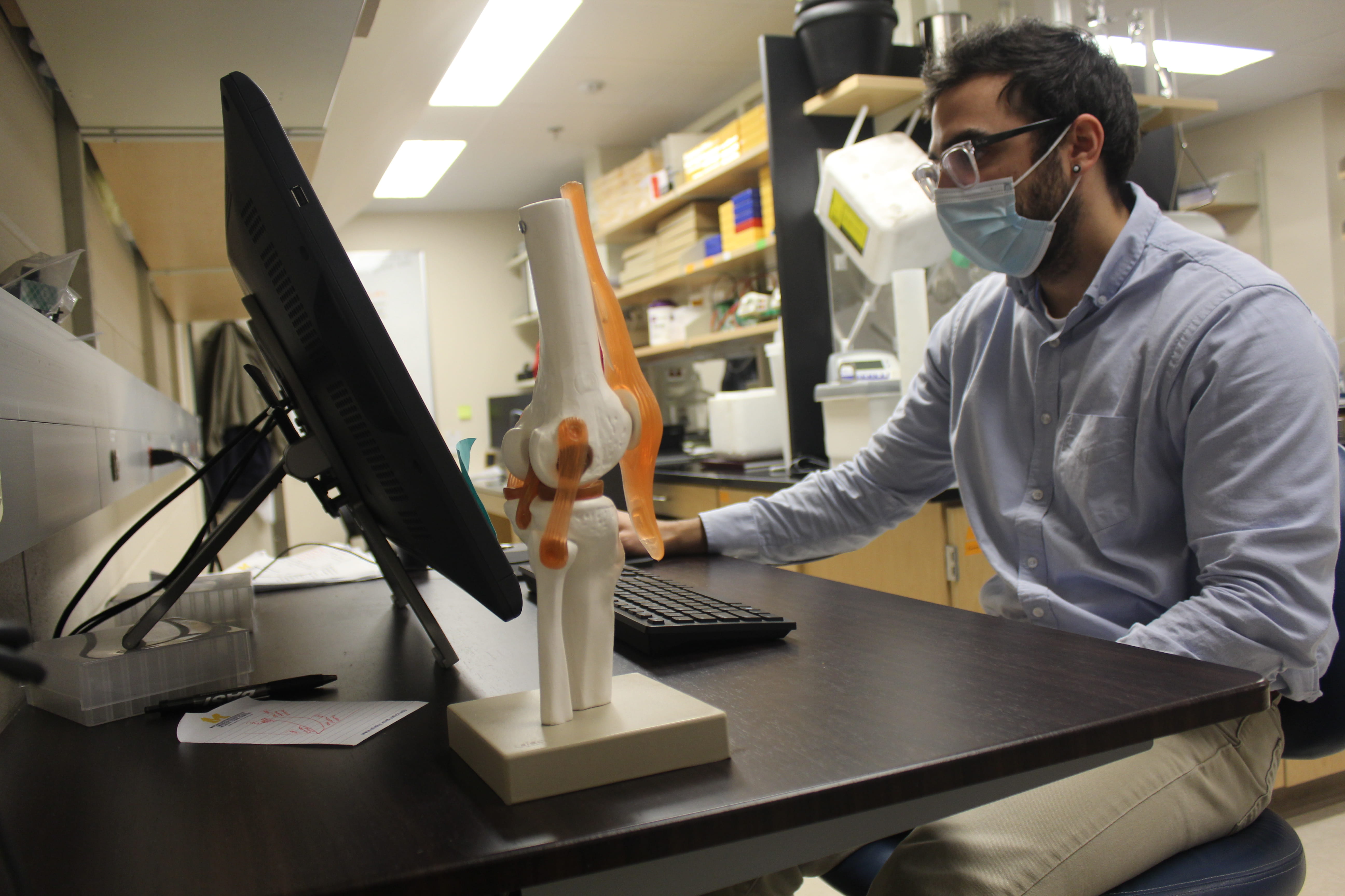 A researcher works at a computer in Schlecht Lab